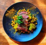Sliced Sirloin Steak On A Bed Of Chick Peas
